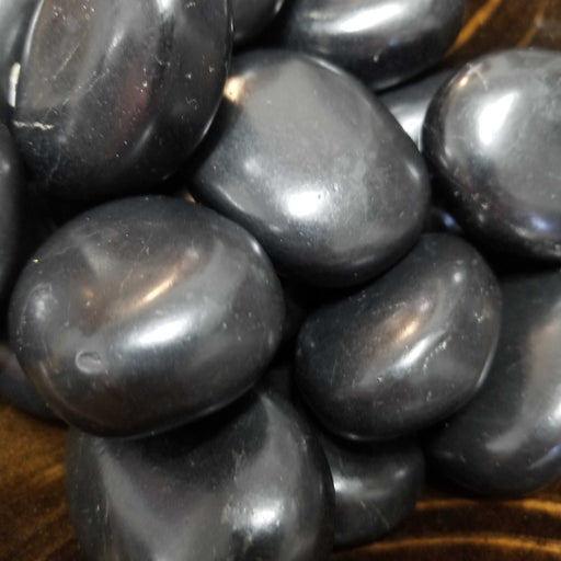 Close-up image of Shungite Palm Stones from High Ho Gems and Crystals, perfect for reducing electromagnetic emissions and transmuting EMF.