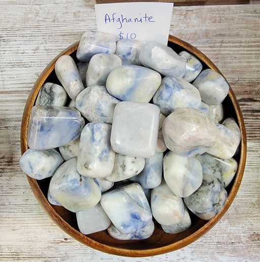 Afghanite: The Celestial Blue Stone of Intuition and Clarity, featuring stunning Afghanite Tumbled crystals showcasing their rich celestial blue hues and unique textures.