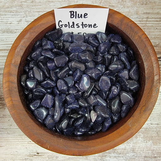 Beautiful Blue Goldstone Tumbled crystal showcasing dark blue color with sparkles from flecks of copper, perfect for promoting vitality and soothing anxiety-related stomach complaints.