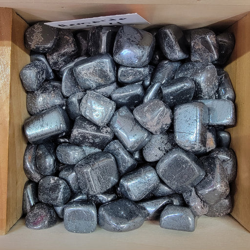 Hematite tumbled stones showcasing their silver and gray color, ideal for absorbing negative energy and enhancing focus.