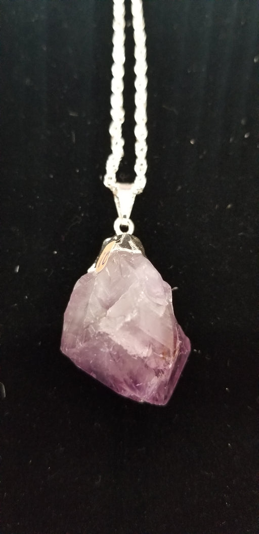Jewelry featuring an Amethyst nugget pendant, elegantly wrapped in silver. Ideal for enhancing intuition and promoting peace of mind.