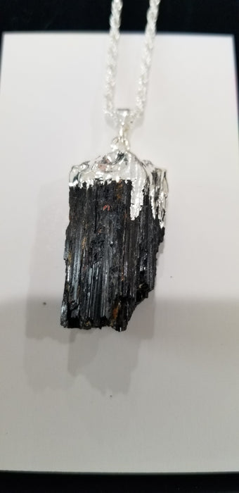 Jewelry - Black Tourmaline Pendant Silver capped, showcasing a polished black tourmaline stone capped in silver, ideal for removing negative energies and promoting a healthy mood.