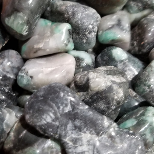 Tumbled stones featuring natural green Emerald tumbled for healing and decoration, perfect for crystal enthusiasts.